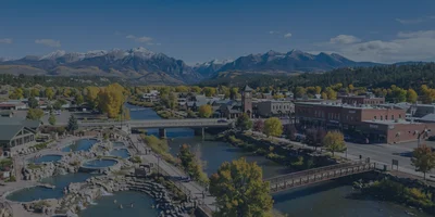 A professional graphic showing standard real estate icons for pricing and inventory trends, overlaid on a natural photograph of Pagosa Springs, Colorado, illustrating market health.